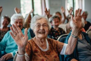 Older adults gathered at a garden table, painting pots and chatting under afternoon sunlight.