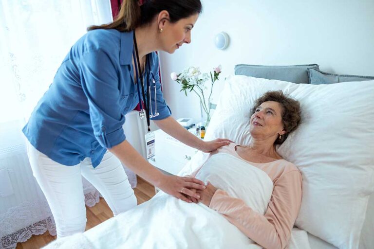 Care coordinator reviews a resident’s medication list and appointment calendar at an assisted living table.